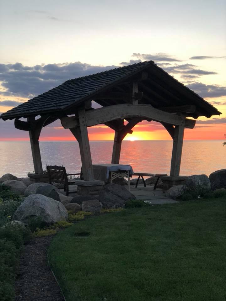 Massage pavilion in front of a colorful Lake Erie Sunset