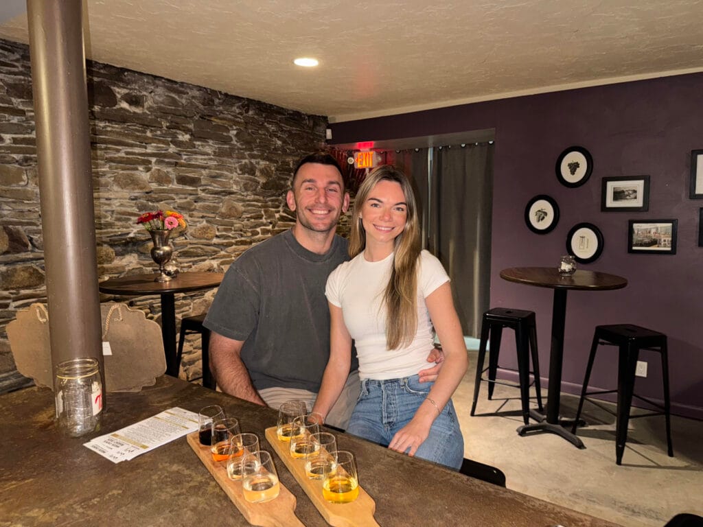 Couple wine tasting at South Shore Wine Company in the stone cavern tasting room in North East, Pennsylvania